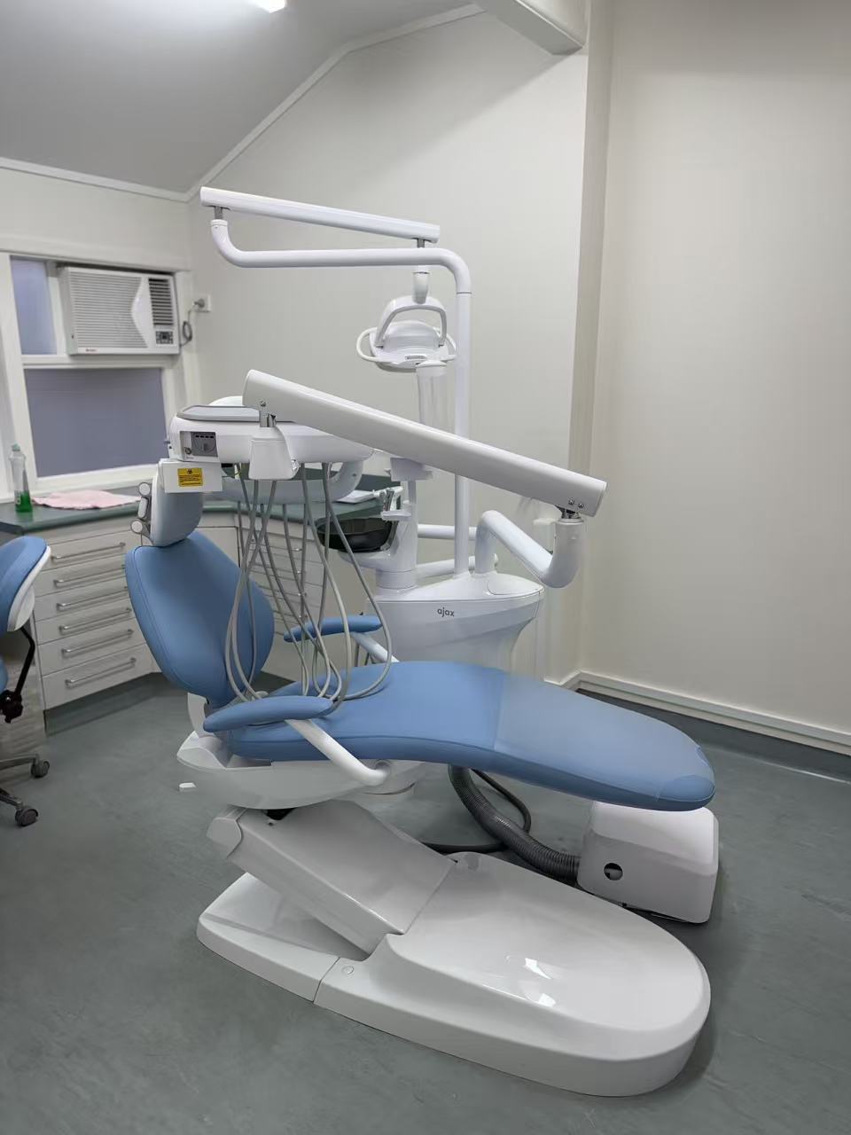 Smile Care Auckland treatment room with blue dental chair