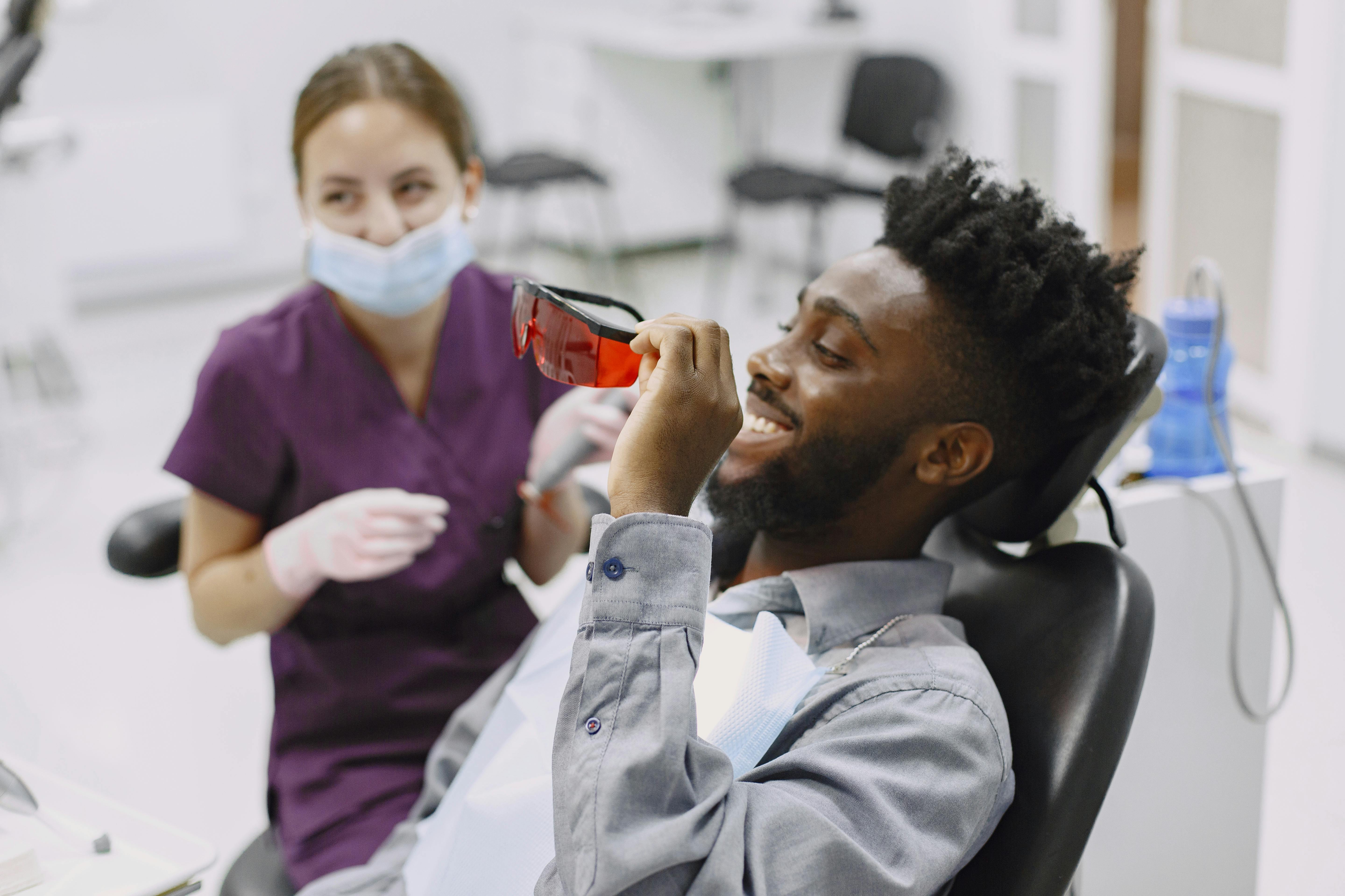 Smiling dental patient with a dentist in a modern clinic